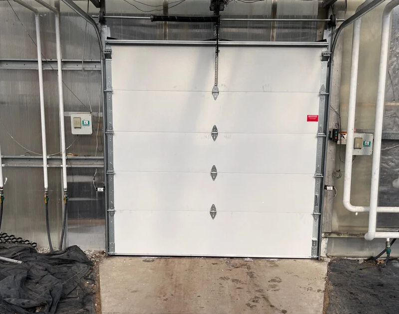 Skilled technician performing professional garage door installation at Mariner Garage, showcasing a brand new, modern garage door with a focus on high-quality service and customer satisfaction. Mariner Garage Door Repair logo visible.