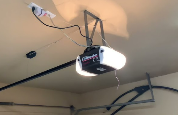 Technician performing a precise garage door opener installation using modern equipment, provided by Mariner Garage Door Repair.