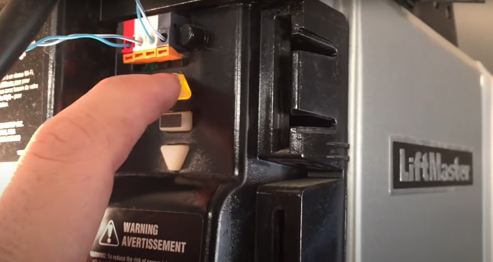 Professional technician repairing a garage door opener mechanism with tools and equipment, highlighting expert garage door opener repair services by Mariner Garage Door Repair.