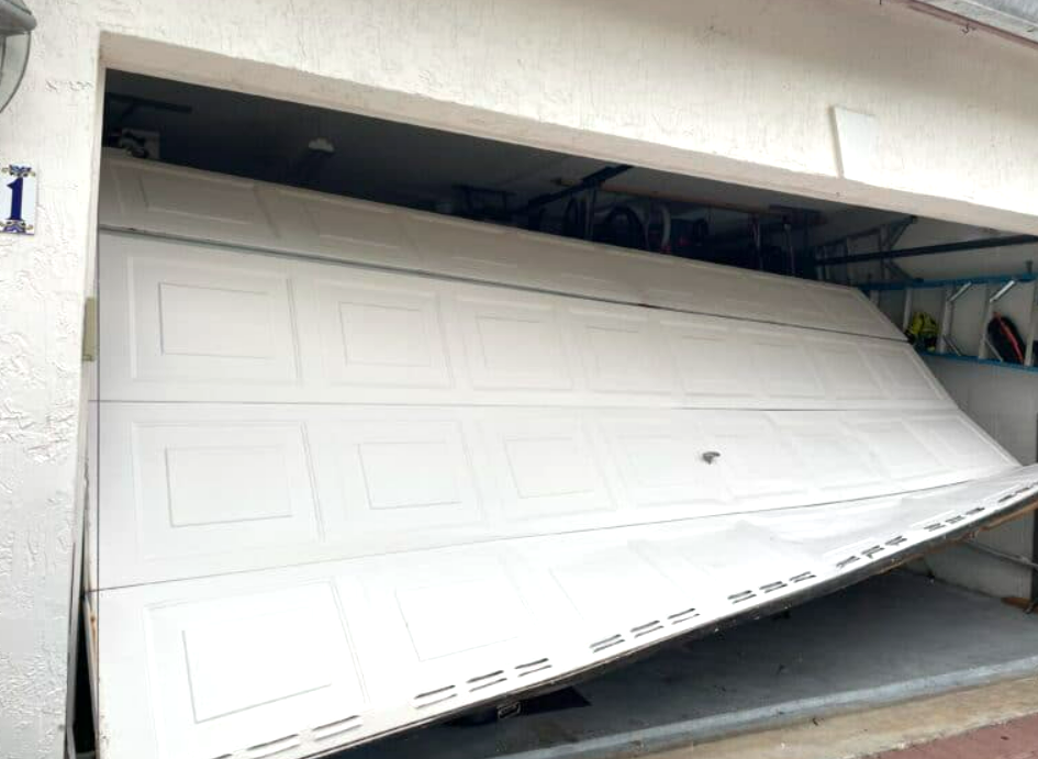 Professional technician replacing a damaged garage door section with specialized tools at Mariner Garage Door Repair, showcasing expert garage door section replacement services