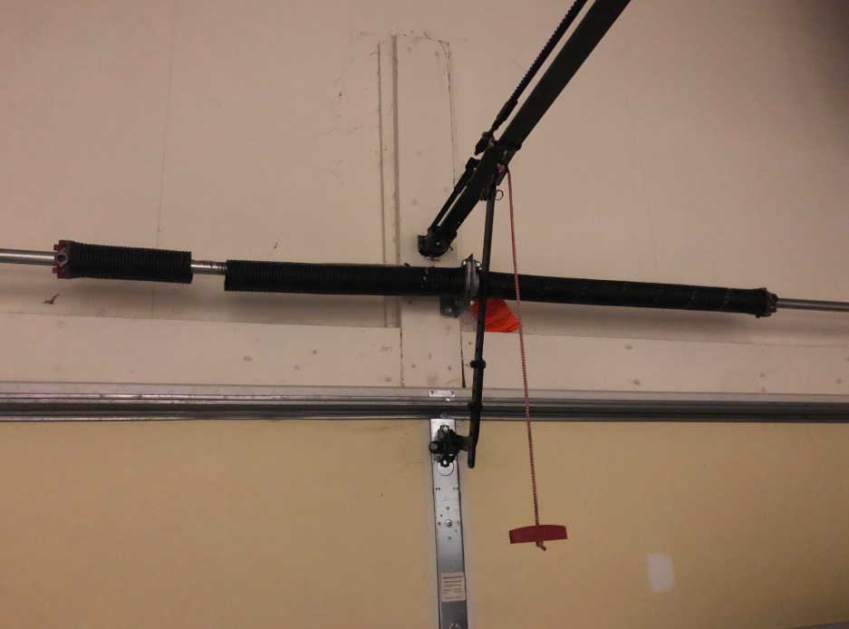 Expert technician performing garage door spring repair at Mariner Garage Door Repair, ensuring seamless operation and enhanced safety.